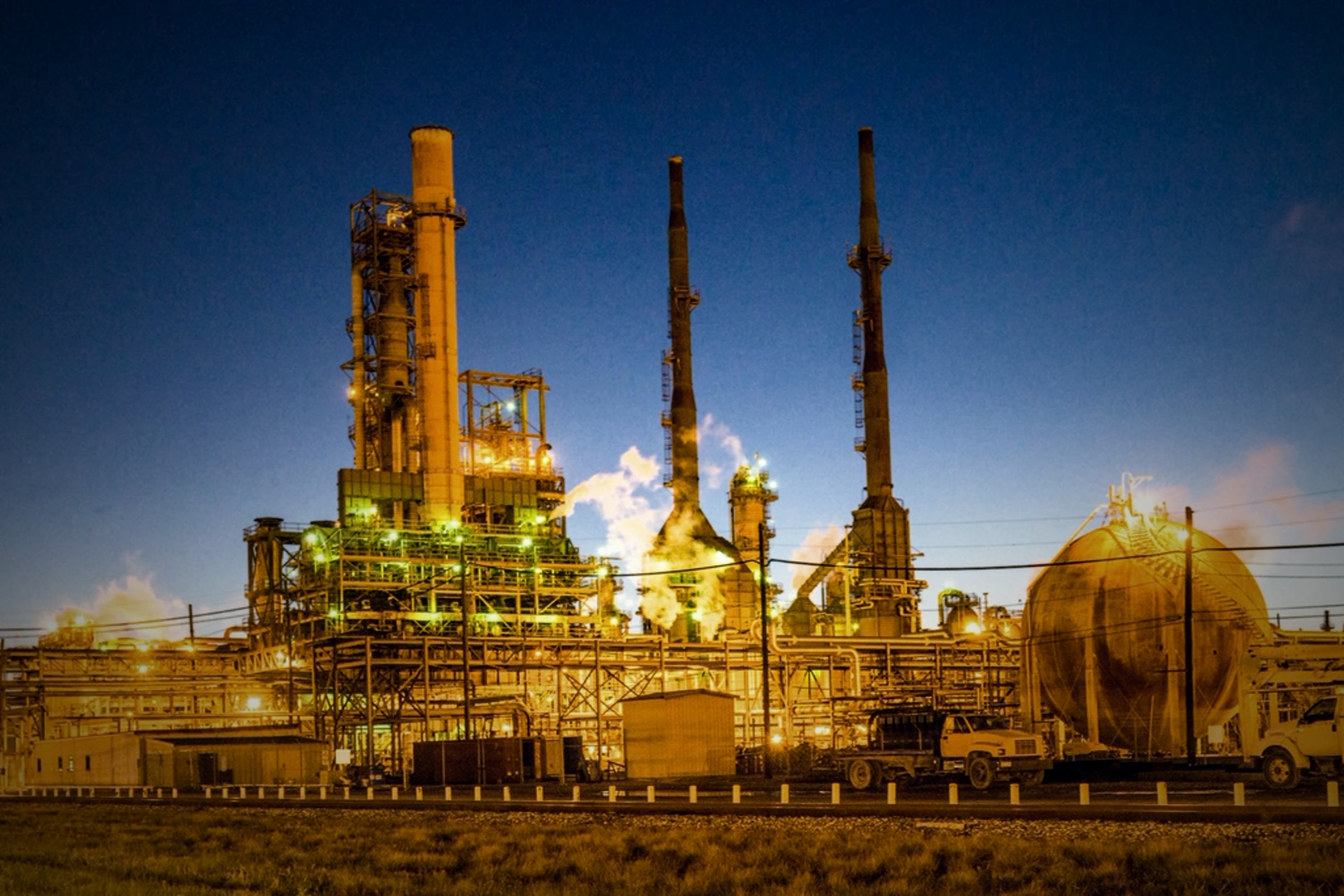 A refinery lit up at dusk